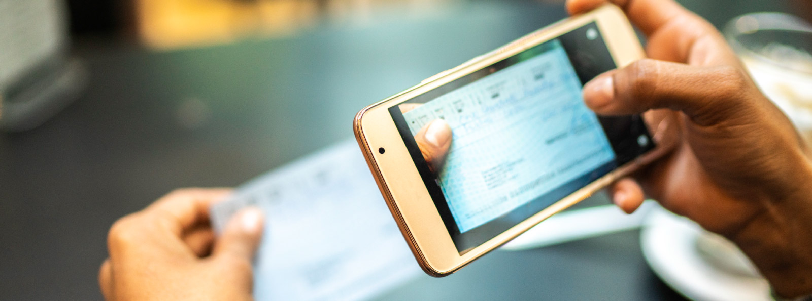 Person taking picture of check to deposit electronically
