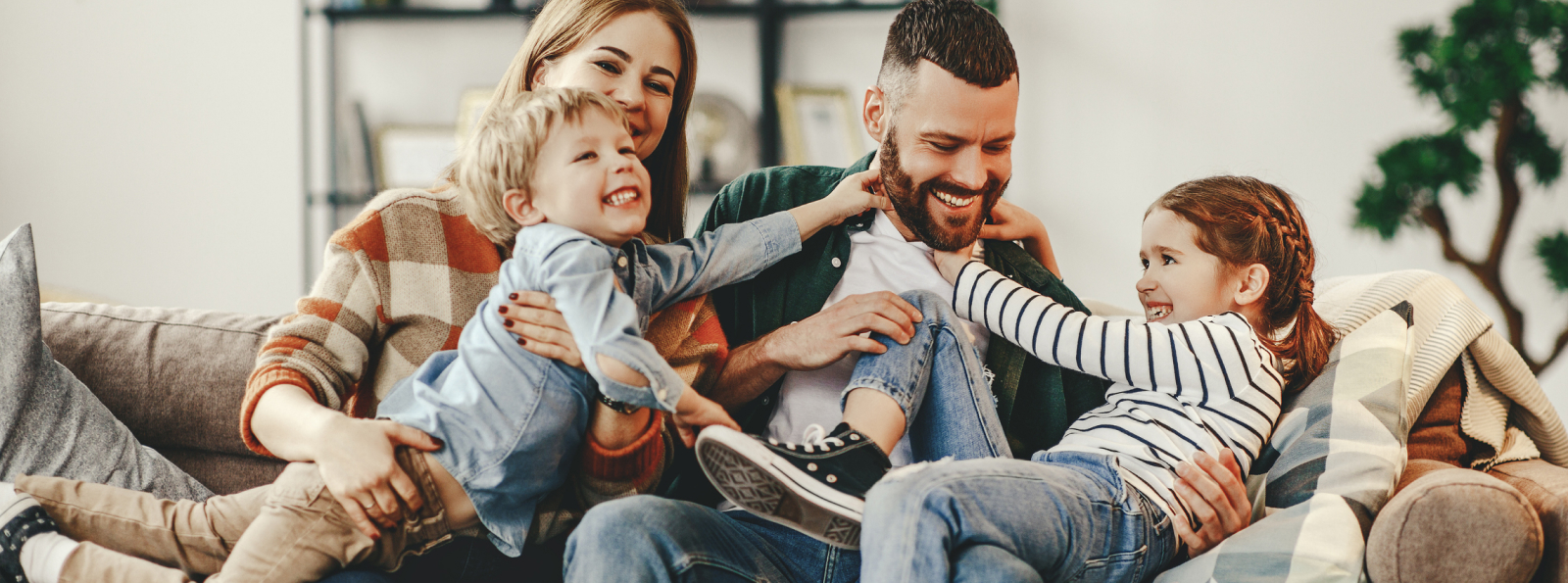 Family sitting together and laughing on couch