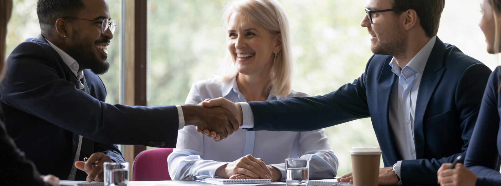 Men shacking hands at business meeting